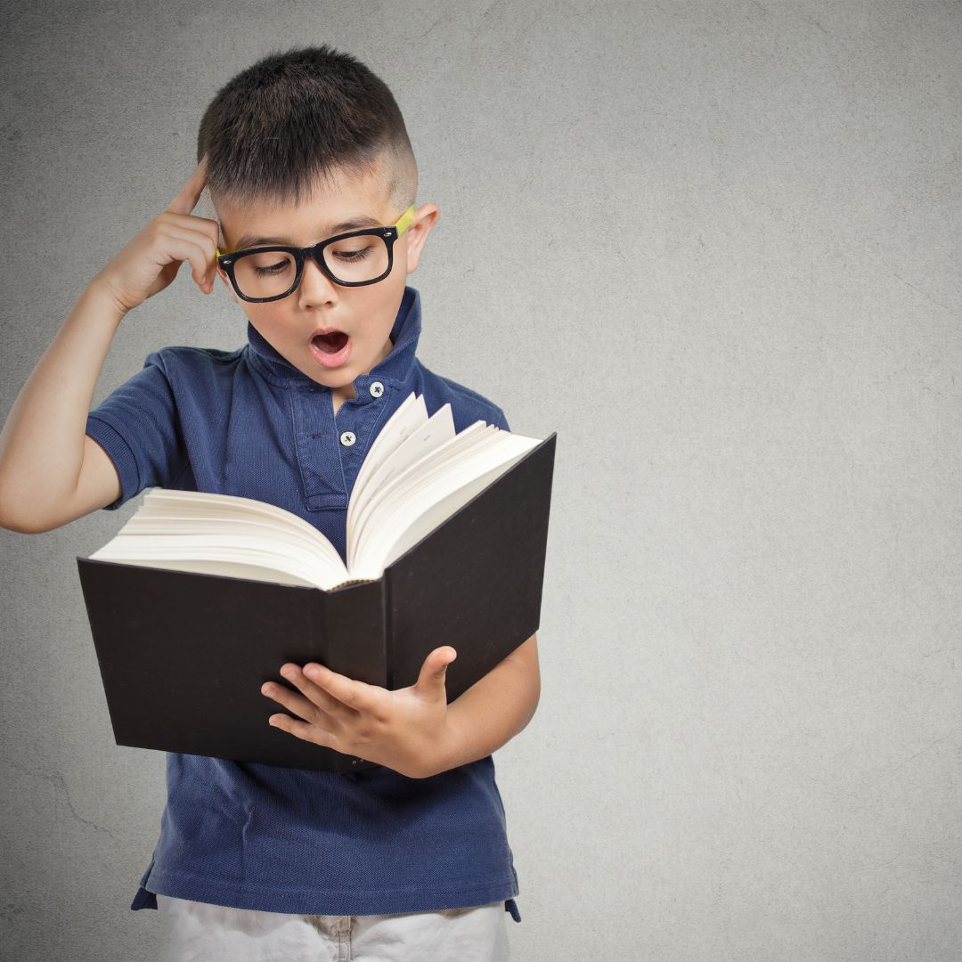 kid scratching his head in thought while reading