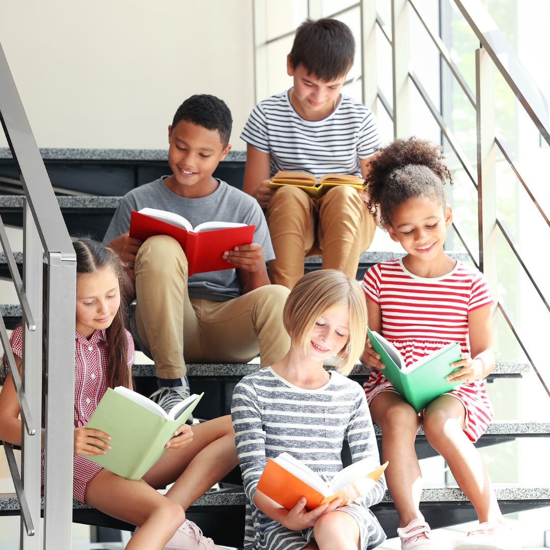 kids sitting on the stairs reading
