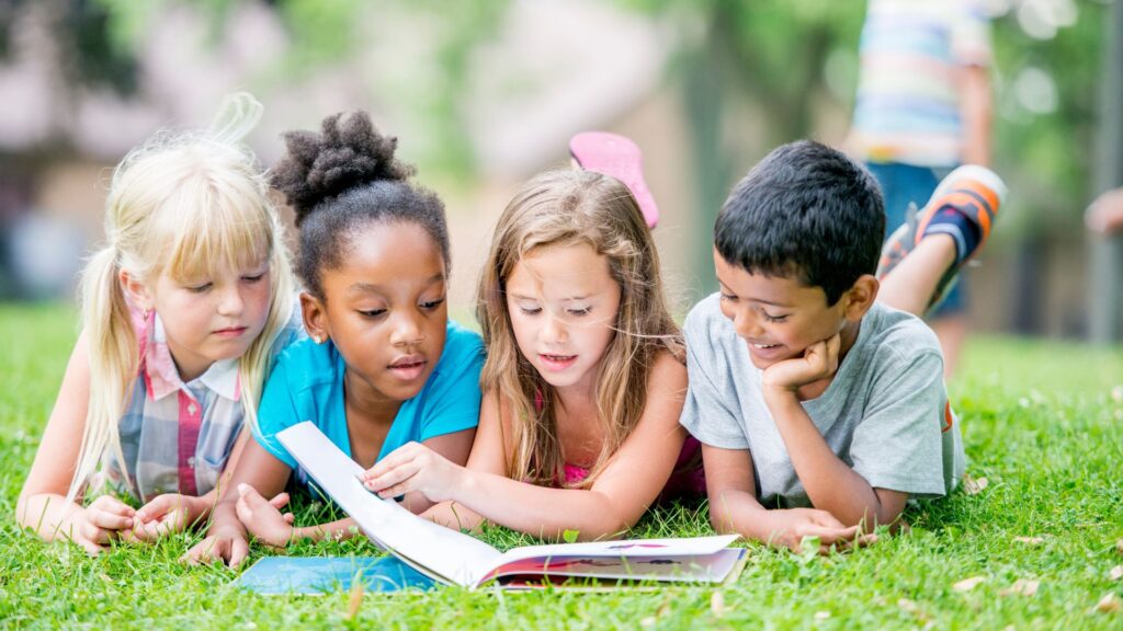 group of kids reading outside